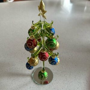 10 1/2” tall glass Christmas tree with glittered ball ornaments.